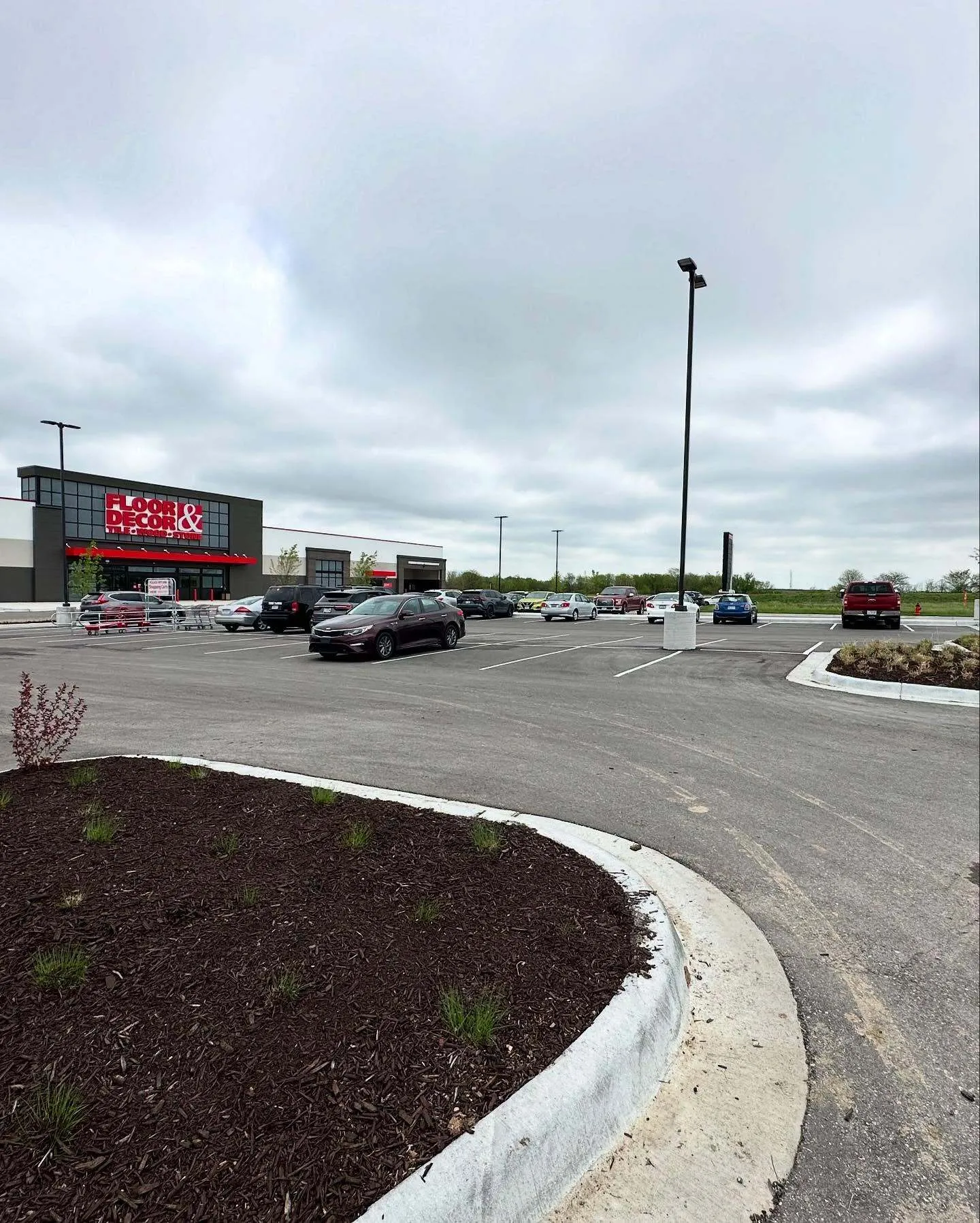 Fresh mulch bed installation by Urban Diamond landscaping crew