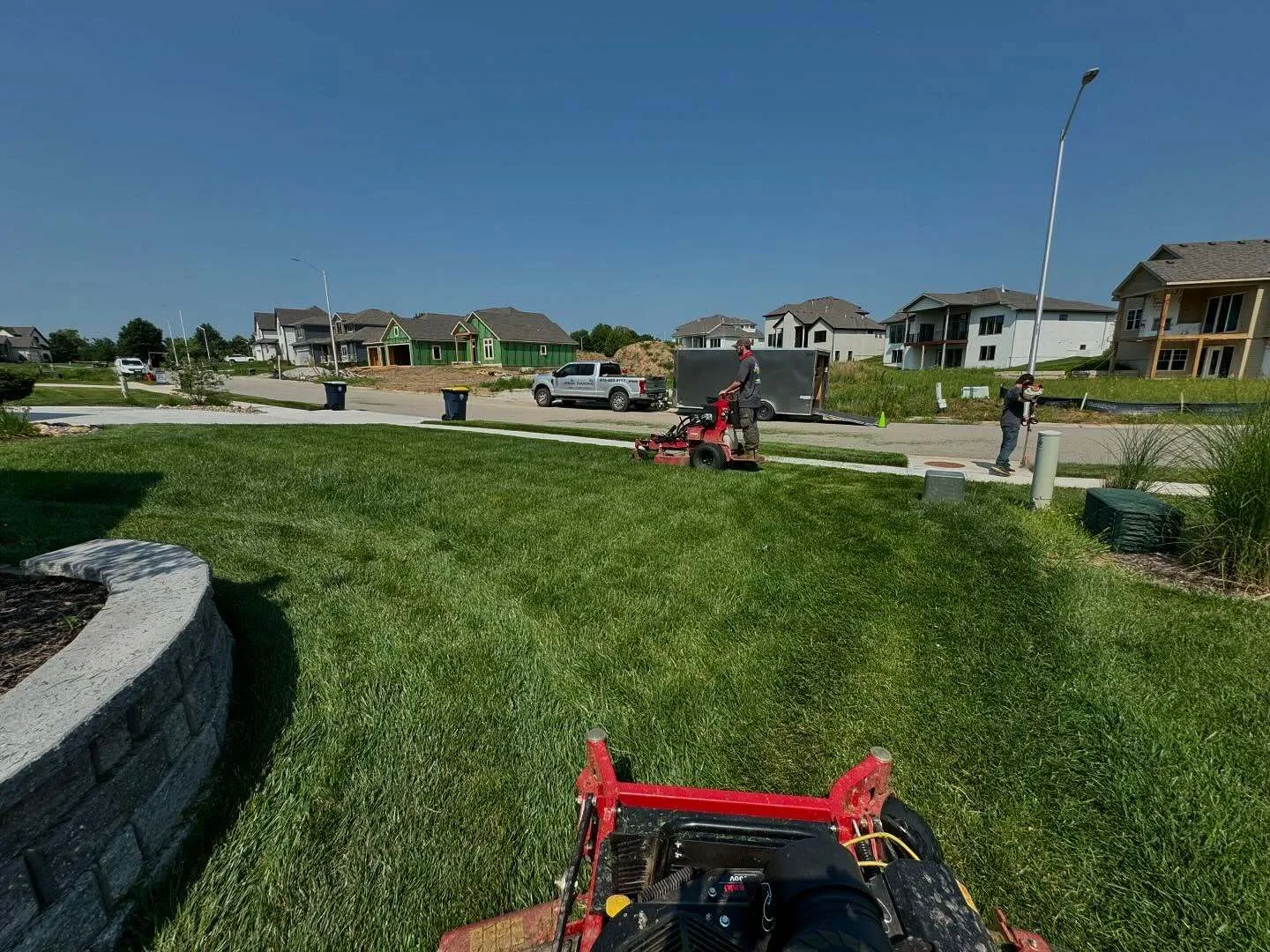 Professional lawn mowing equipment used by Urban Diamond crews