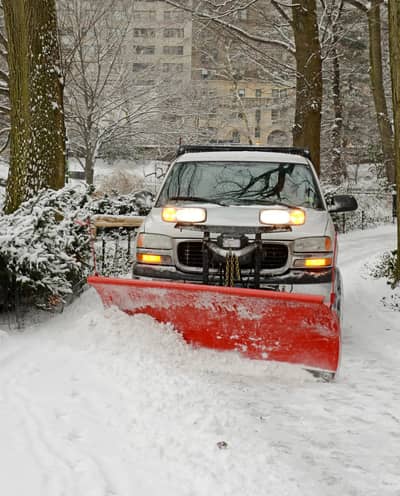 Snow plow clearing commercial property