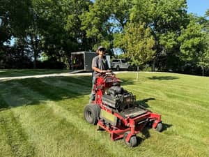 Urban Diamond team member operating professional mower